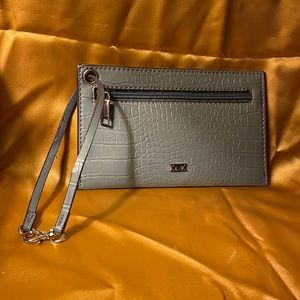 Collection XIIX grayish blue wristlet with detachable strap.